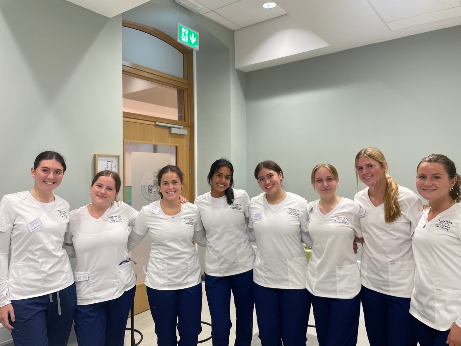 Eight nursing students in white tunics who helped run the practical training at our latest workshop